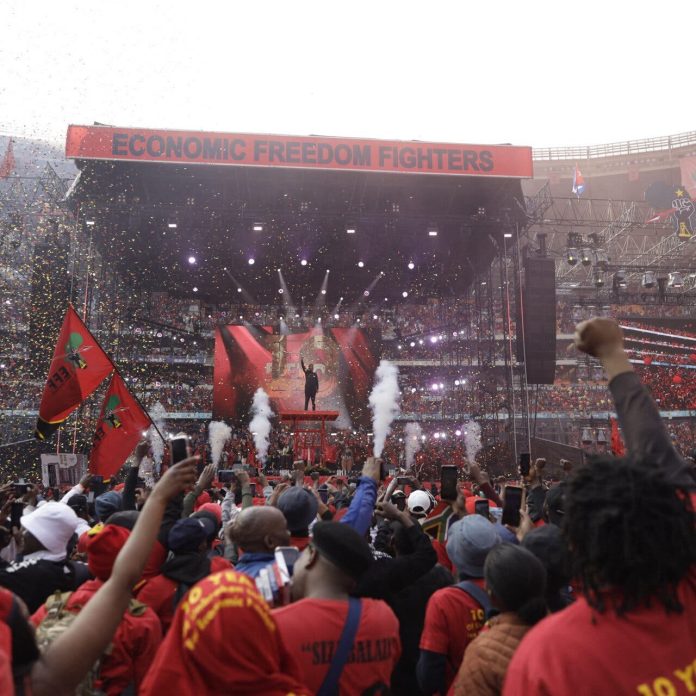 Julius Malema gesticulando desde el escenario durante las celebraciones del décimo aniversario de su partido político en Johannesburgo en 2023 | Guillem Sartorio/Agence France-Presse — Getty Images